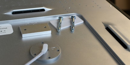 There are two hanging points on the back; one for portrait and one for landscape format