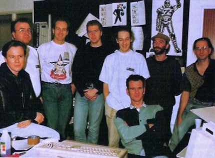 Die Bitmap Brothers, circa 1990.  Fromo left to right: Eric Matthews, Mike Montgomery, Tom Watson, Sean Griffiths, Rob Trevillion, Dan Malone (sitting), Richard Joseph and Steve Kelly