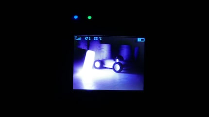Somehow eerie: the room is dark, but the LED on the baby monitor display is lit up.