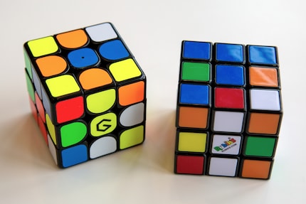 The Supercube on the left, the conventional Rubik's Cube on the right.