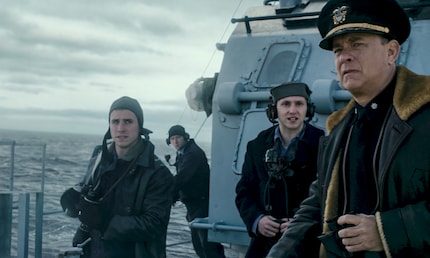 A doubtful Captain Krause, keenly observed by his crew.