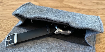 The fabric case is special packaging for a wristwatch.