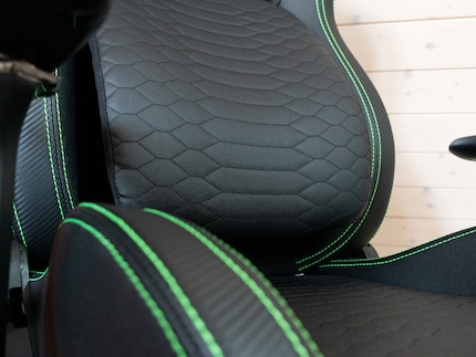 Imitation leather and green stitching.