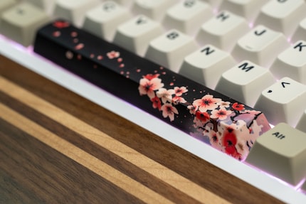 The cherry blossoms unfold over the entire length of the space bar.