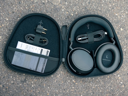 The hard case comes with a few accessories: A long USB cable, an aux cable, an aeroplane adapter and a short user manual.