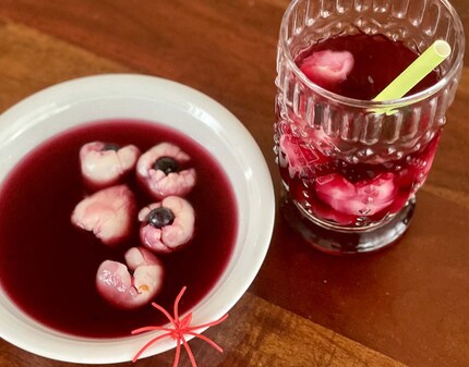 Sweet, not sour: blood red eyeball punch with grape juice, lychees and blueberries.