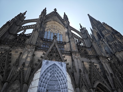 Cologne Cathedral in the shade with the bright sky in the back.