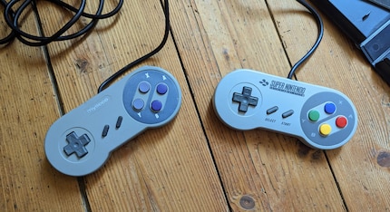 The third-party controller (left) feels even cheaper than the original. But on the plus side, the start button actually works.