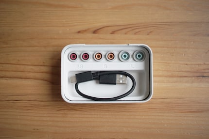  Sony supplies attachments in four different sizes. Plus a mini charging cable.