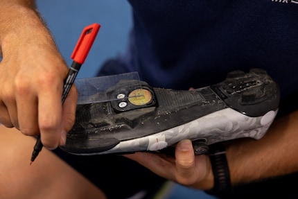 Adjusting the position of the cleats on the shoes.