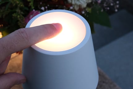 Place your finger on the lamp and it switches on. Leave your finger in place and it brightens up.