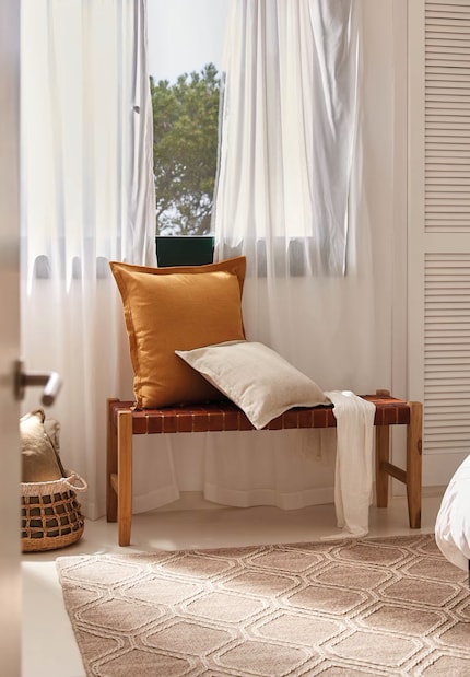 A comfortable bench by the window is perfect for reading, looking outside and daydreaming.