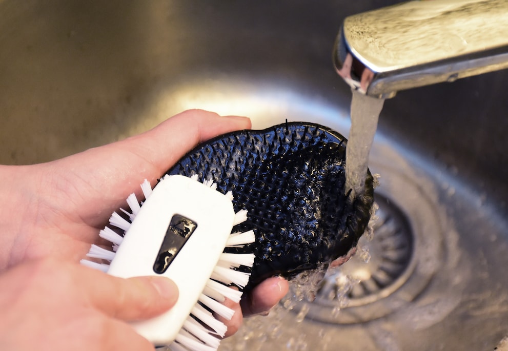 A dishwashing brush and some soap is enough to clean the Tangle Teezer in no time at all.