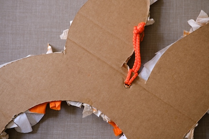 Attach a piece of string to hang up your new Easter wreath.