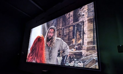 I watch the razor-sharp image of the VisionMaster Max on an impressive 210-inch screen.