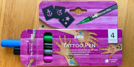 The set includes four pens and three stencils.