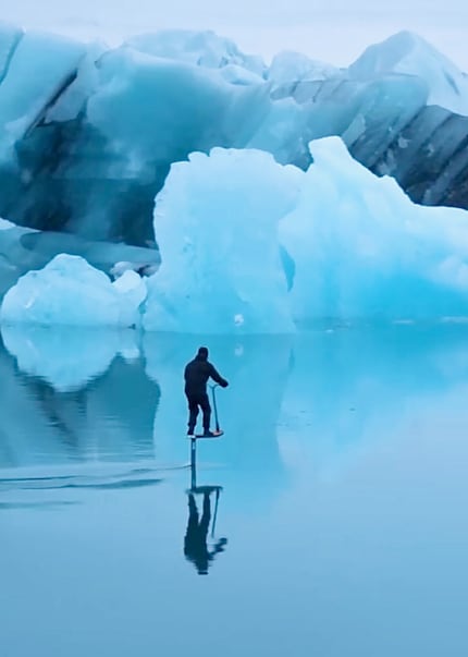 A fascination with ice: Benji floats past icebergs on his foil scooter.