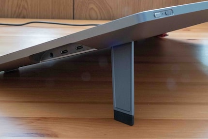 On the side: two USB-C ports for power and devices; on the top: touch slider and power button.