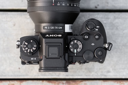 The two stacked mode dials each control two functions: Focus mode and drive mode on the left, shooting mode and switching between photo and video on the right.