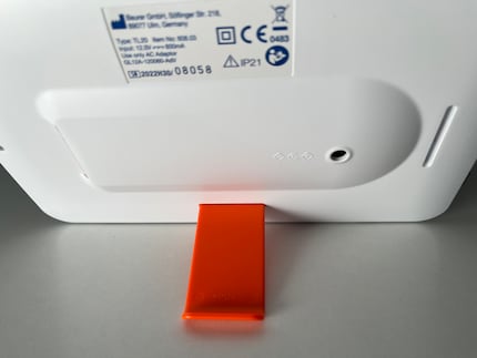 The orange stand can be easily repositioned. Attached to the long side, the lamp is in landscape format ...
