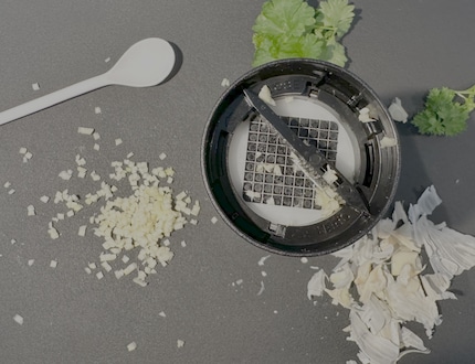 A part of the garlic clove gets stuck in the grid. Knocking it off helps, or you can pulp it out with a spoon.