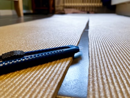 The carpet knife glides through the mat more easily than I’d expected. So easily, in fact, that the cut edges become slightly crooked. Oops!