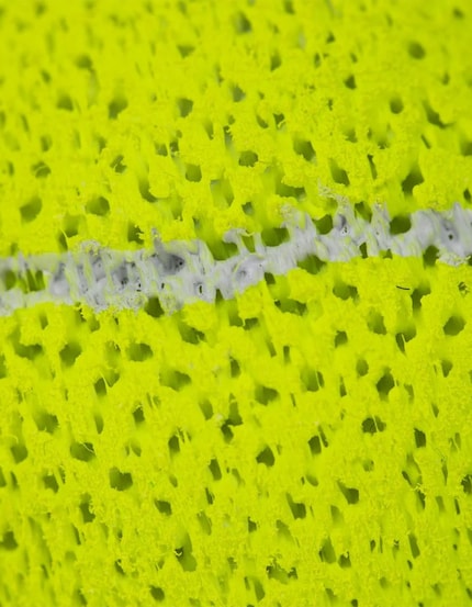 Close-up of the honeycomb-like surface: the 3D printed structure replaces the rubber and felt of conventional tennis balls.