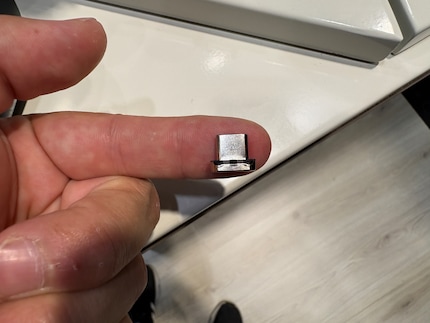 The small dongle must be placed in the USB-C port of your AirPods Max.